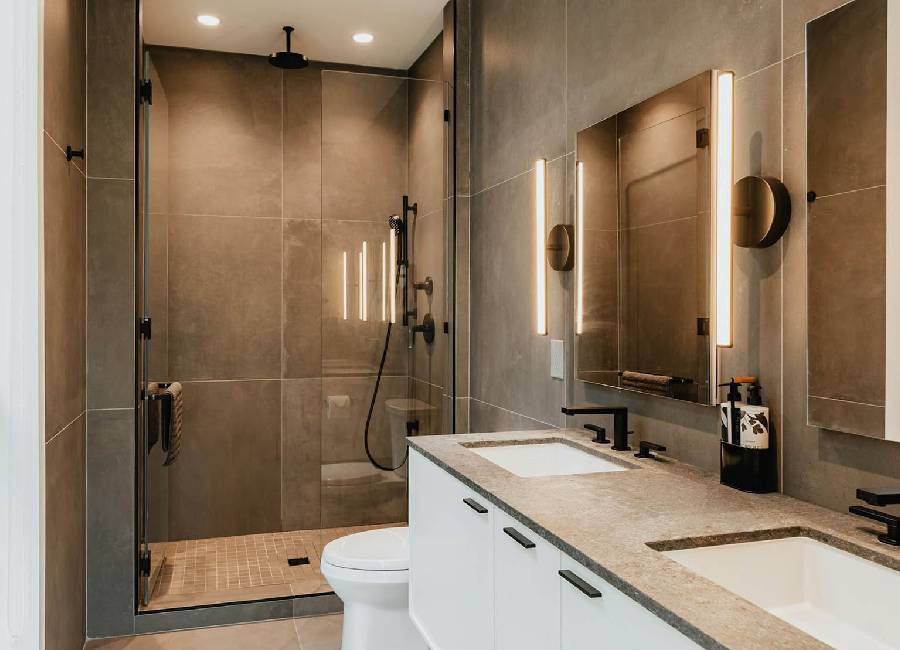 Luxury bathroom remodel with freestanding tub, marble surfaces, and abundant natural light